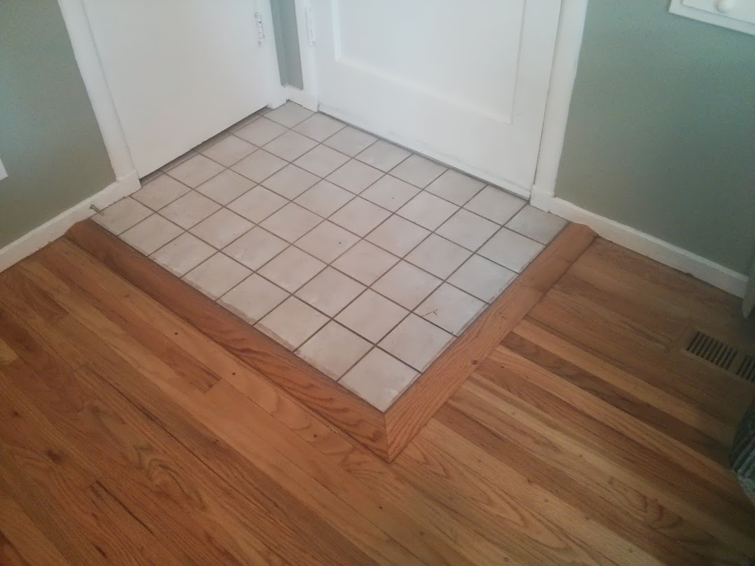 This floor had tile over the original hardwood flooring.  After removing the carpet I refinished the floor and installed this threshold to clean up the transition to the refinished hardwood floor.