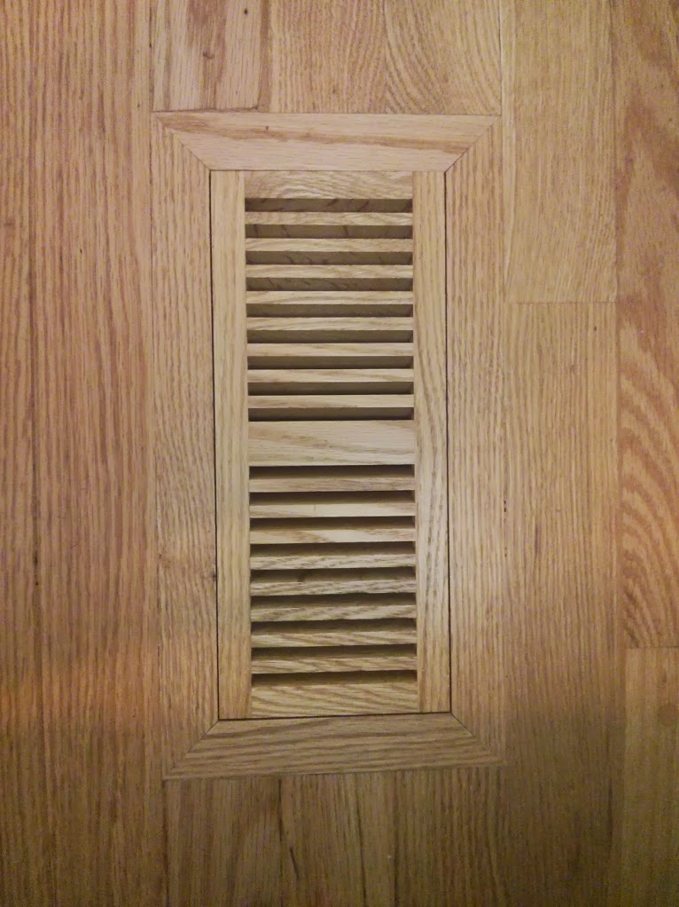Flush mount oak floor vent.  Cut and inlaid the floor vent into an existing hardwood floor.  Sanded flush with the floor and and finished.